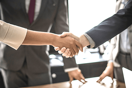 people shaking hands at a business meeting