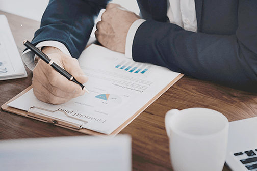 Man looking at a financial plan on a clipboard