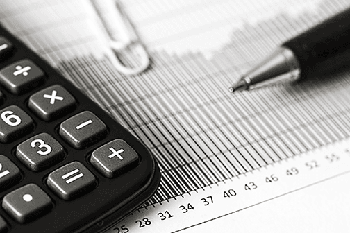 Calculator and pen sitting on top of a graph