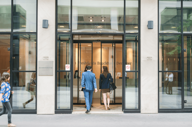 people walking into an office building