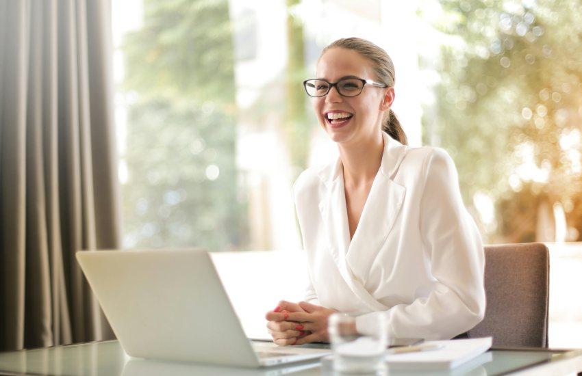 Woman smiling at a laptop